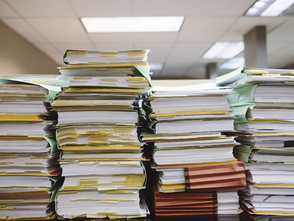 Stacks of paper documents and file folders