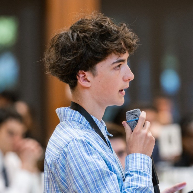 Samson Cournane speaking into a microphone
